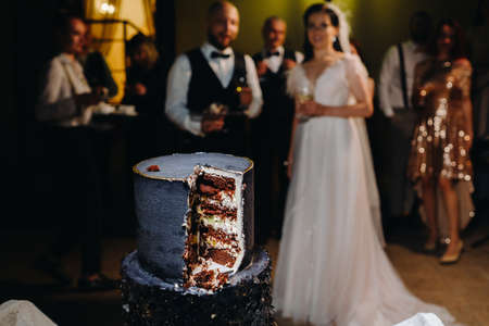 A close-up cut of a wedding cake at a wedding.の写真素材
