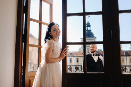 Elegant wedding couple on the balcony of an old castle in the city of Nesvizh.の写真素材