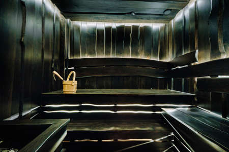Bucket and ladle in a wooden sauna. Wooden accessories in the sauna.の写真素材