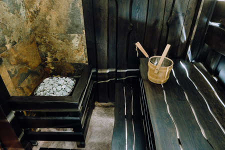 Bucket and ladle in a wooden sauna. Wooden accessories in the sauna.の写真素材