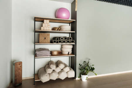 Sports equipment for yoga classes is on the shelf in the gym.の写真素材