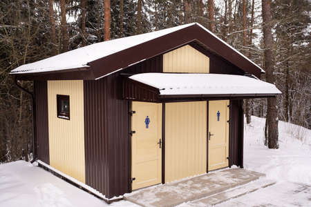 Mens and womens toilets standing in a snowy forestの写真素材