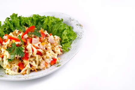Salad trends. Salad with ham, paprika, pepper and cheese on a white isolated background.の写真素材