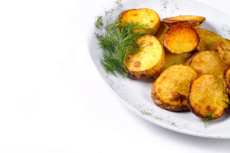 Fried potato slices on a white plate with dill isolated on a white background.の写真素材