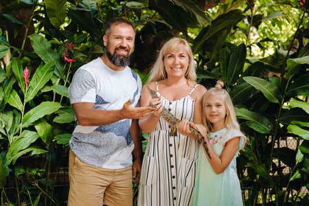 A family on the island of Mauritius with a small crocodile in their hands.の写真素材