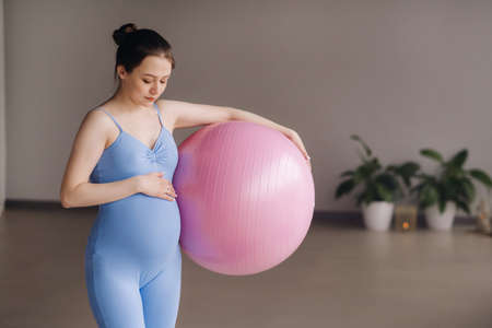 Pregnant woman during fitness classes with a fitball.の写真素材
