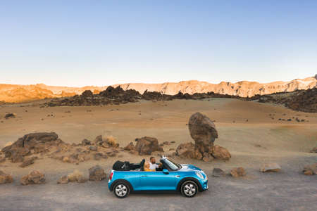 a married couple sits in a car on the island of Tenerife in the crater of the Teide volcano, Spain.