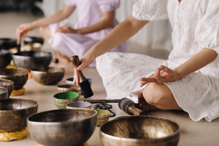 Close-up of a Tibetan singing bowl in your hands - Translation of mantras: transform your impure...