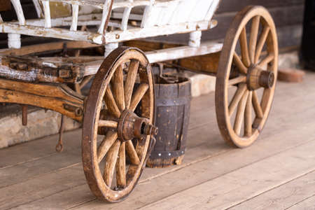old wooden wheels are on the carriage at the ranch.の写真素材