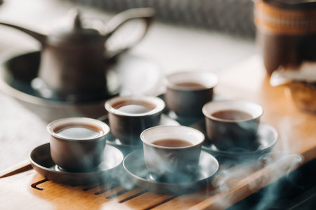 Cups with poured tea before the tea ceremony with incense.の写真素材
