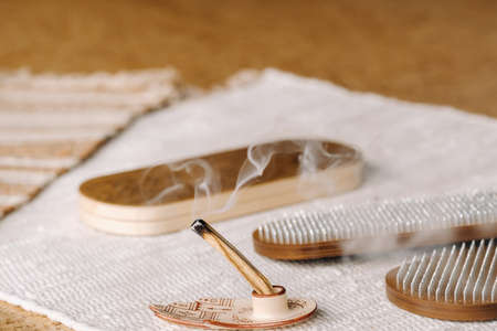 A smoking Palo Santo stick and boards with nails for yoga classes.の写真素材