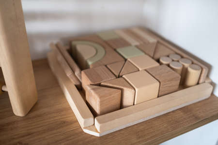 A shelf with children's wooden toys in the children's room. children's concept.