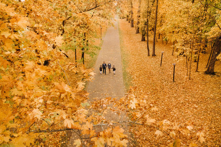 A large family walks in the park in the fall. Happy people in the autumn parkの写真素材