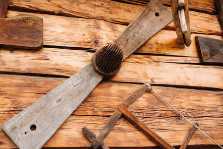 Old wooden wall of a house in the village and tools on the wall.の写真素材
