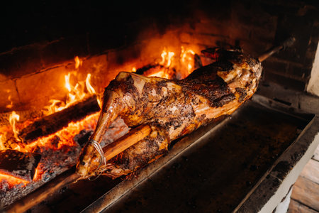 The lamb is cooked entirely on a spit on the fire. Cooking.の写真素材