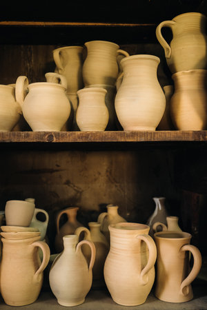Ceramic clay jugs standing on a shelf in the village.の写真素材