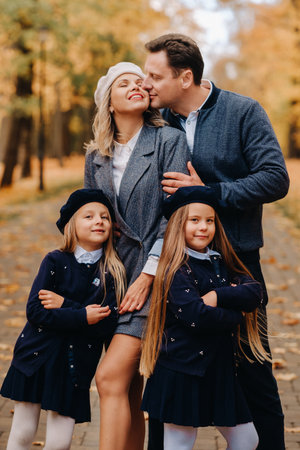 A large family walks in the park in the fall. Happy people in the autumn parkの写真素材