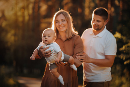 Happy family of three in the summer in the park in nature