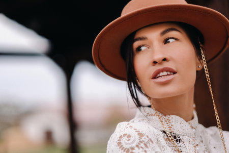 Beautiful girl in vintage lace dress and hat at the ranch