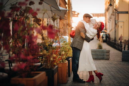 Portrait of a happy couple hugging on the street in an autumn city. Retro stylish couple in autumn in the cityの写真素材