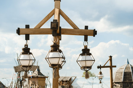 Old wooden lanterns hanging on a wooden pole.の写真素材