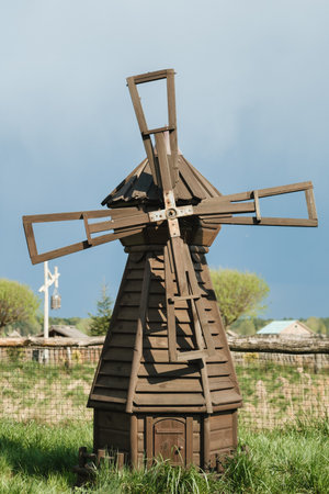 Decorative wooden mill standing outside in summer.の写真素材