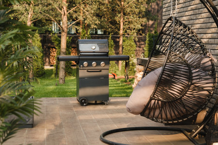 A large barbecue grill stands in the courtyard on the terrace street.