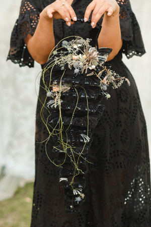 The bride holds her wedding bouquet in her hands.の写真素材