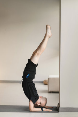 A child practices yoga poses indoors. Children's yoga.