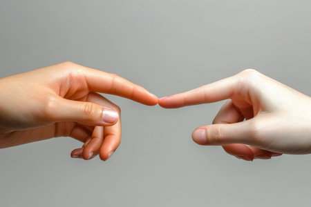 Two hands with fingers tip to tip. contact or communication between people.の素材