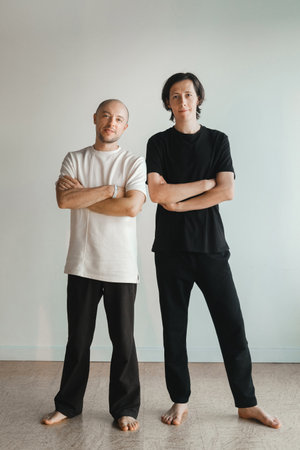 two young athletes practice yoga in the gym. Joint training, indoors, studio. The concept of a healthy lifestyle.の写真素材