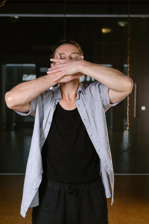 A man performs a randomized movement for yoga at a fitness gym.の写真素材