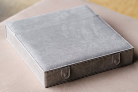 There is a photo book wrapped in a gray cloth in the box. the concept of creating fantasy books and photo albums.の写真素材