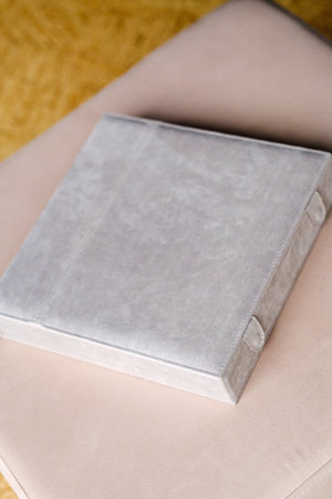 There is a photo book wrapped in a gray cloth in the box. the concept of creating fantasy books and photo albums.の写真素材