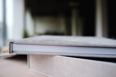 A photo book in a grey cloth cover lies on the box. the concept of creating books and albums from photographs. professional photographer and printing services.の写真素材
