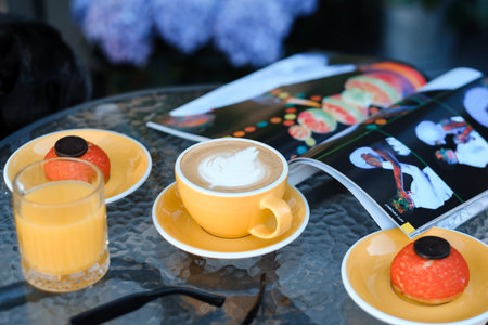 Delicious beverages and desserts enjoyed at a cozy cafe with vibrant decorations and a magazine on a...