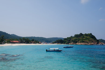 Spectacular scenic view of Long Beach and boats at sea on Redang Island, Malaysia
