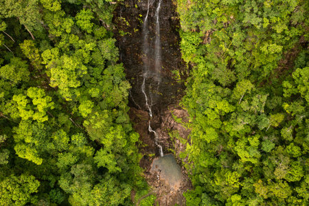 Temurun Waterfall is surrounded by a lush green forest in a remote location on Langkawi Island....