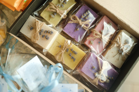 Beautifully crafted handmade soaps in a gift box with lavender and herbs, perfect for personal use...