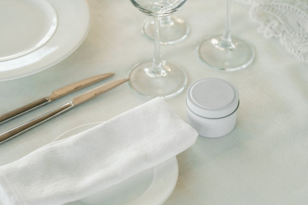 Elegant table setting with silver cutlery, crystal glassware, and a decorative napkin for a special dining occasionの写真素材