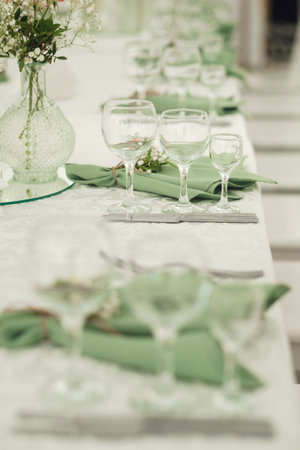 Elegant table setting for a special event featuring glassware and fresh flowers in a serene and...