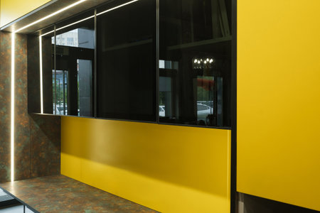 Modern interior design featuring yellow accents and sleek surfaces, showcasing contemporary style in an urban setting during the daytimeの写真素材