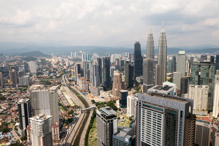 KUALA LUMPUR, MALAYSIA - August 11, 2025. Aerial view of Kuala Lumpur city center with high-rise buildings and roads during the dayのeditorial素材