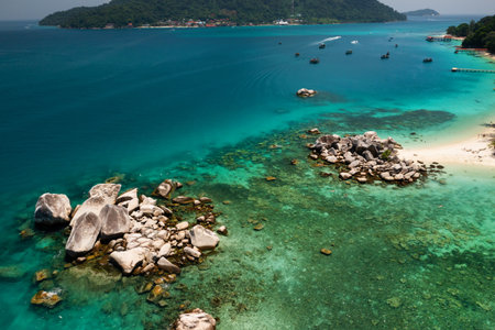 Top view of a secluded beach with crystal clear water and rocky formations on the Perhentian Islands. Malaysiaの写真素材