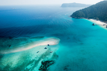 View from the height of the sandy spit with clear blue water, boats and tourists. Redang Island. Malaysia.の写真素材
