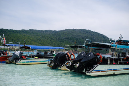 Redang Island. Malaysia. July 27, 2025. Tourist boats with motors are parked on turtle beach on a sunny dayのeditorial素材