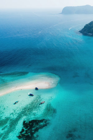 View from the height of the sandy spit with clear blue water, boats and tourists. Redang Island. Malaysia.の写真素材