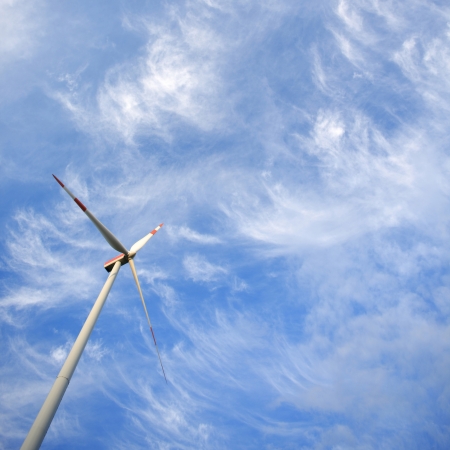 Windmill against blue sky with copy space - renewable energy conceptの写真素材