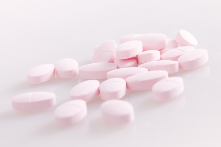 A bunch of vitamin pills on a white backgroundの写真素材