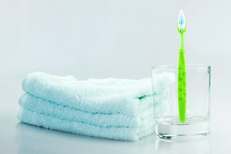 A towel and a toothbrush put togetherの写真素材